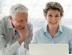 elderly couple looking at computer